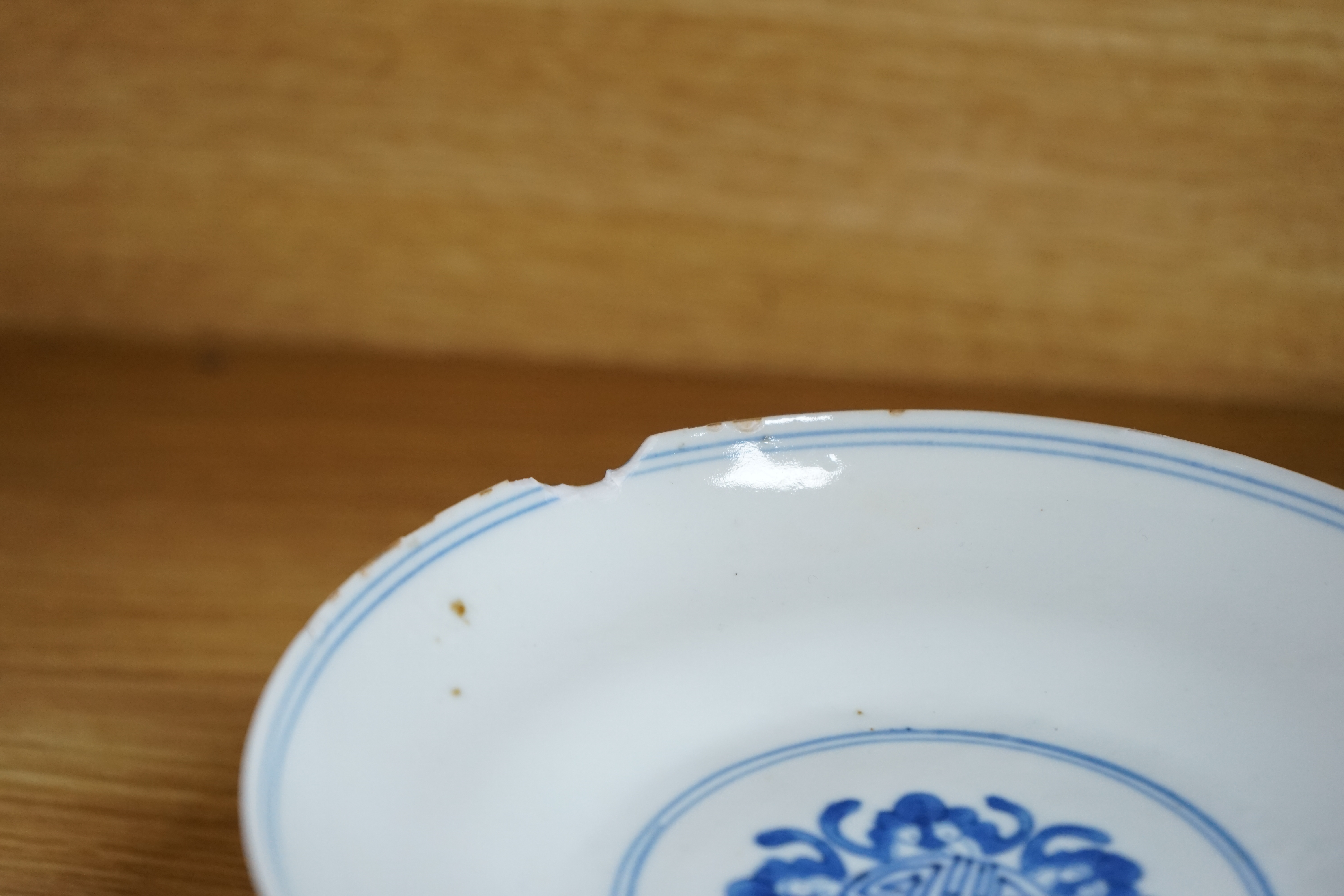 A Chinese blue and white stem dish, Kangxi mark, c.1900. Condition - poor to fair, some significant chipping to rim